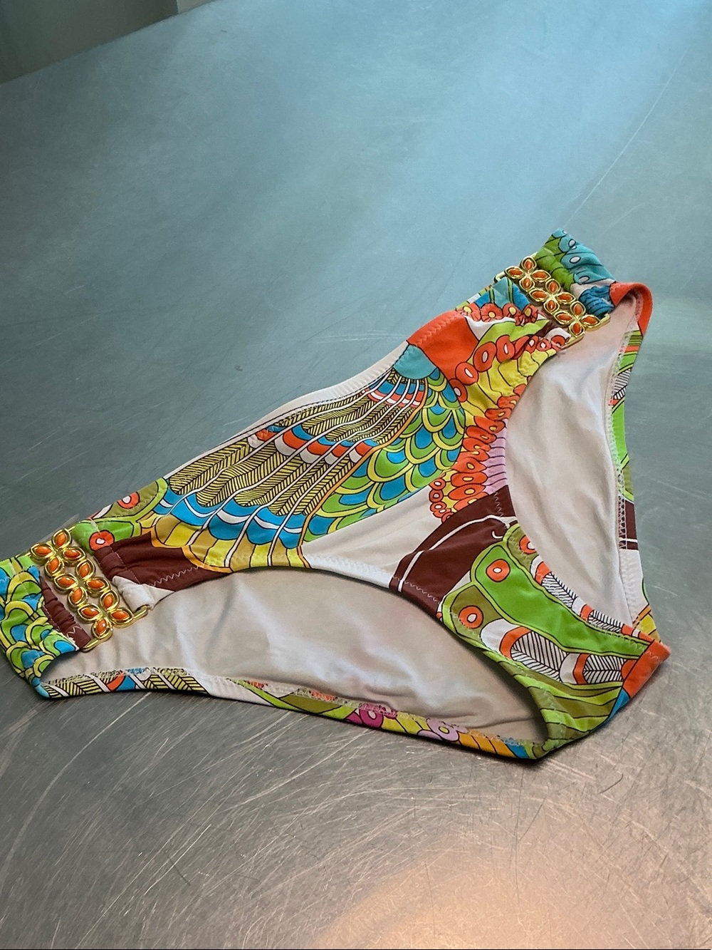 Trina Turk “Paisley Peacock” bikini bottom. Gold/orange metal embellishments.